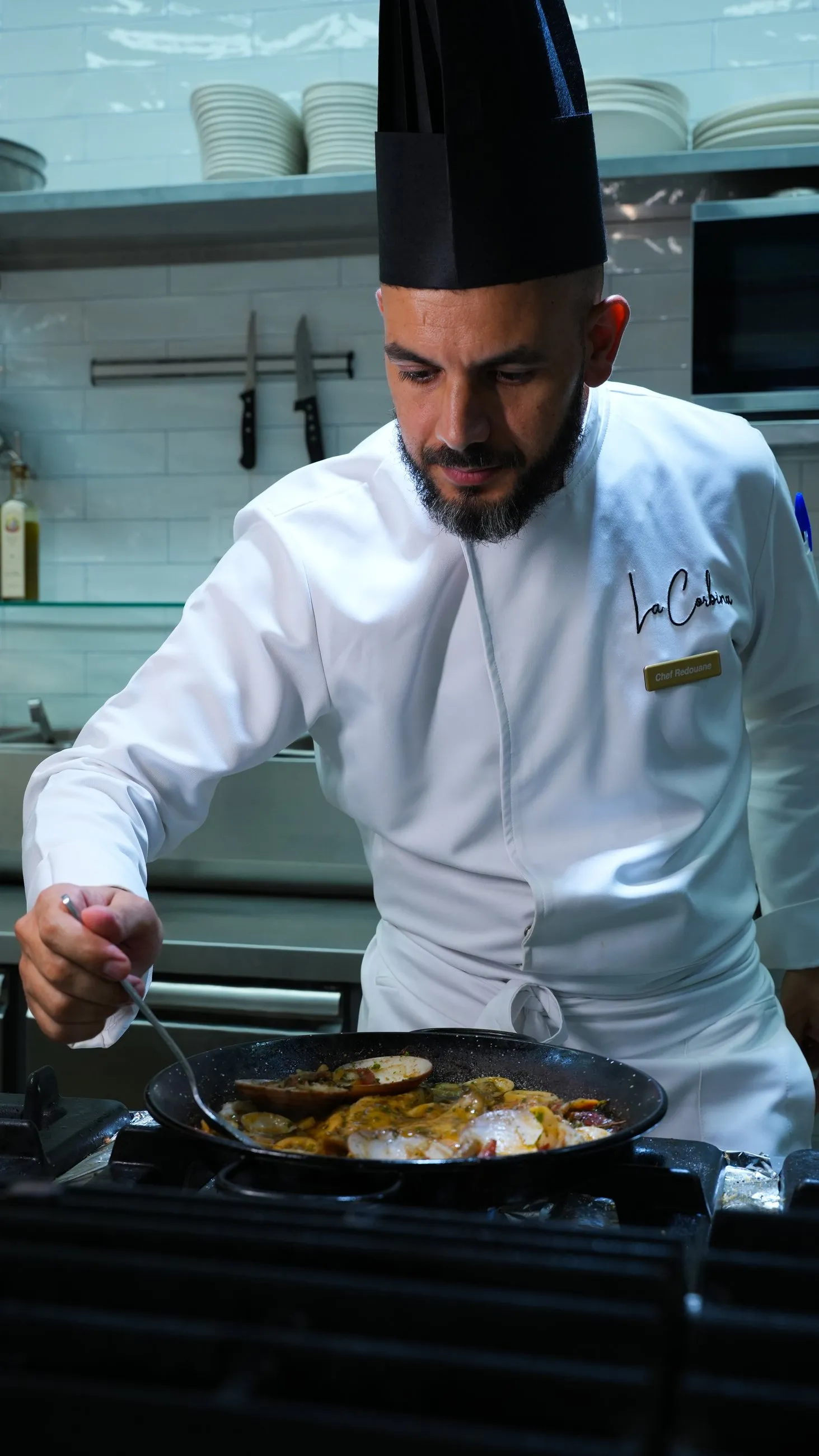A La Corbina chef finishing a seafood dish