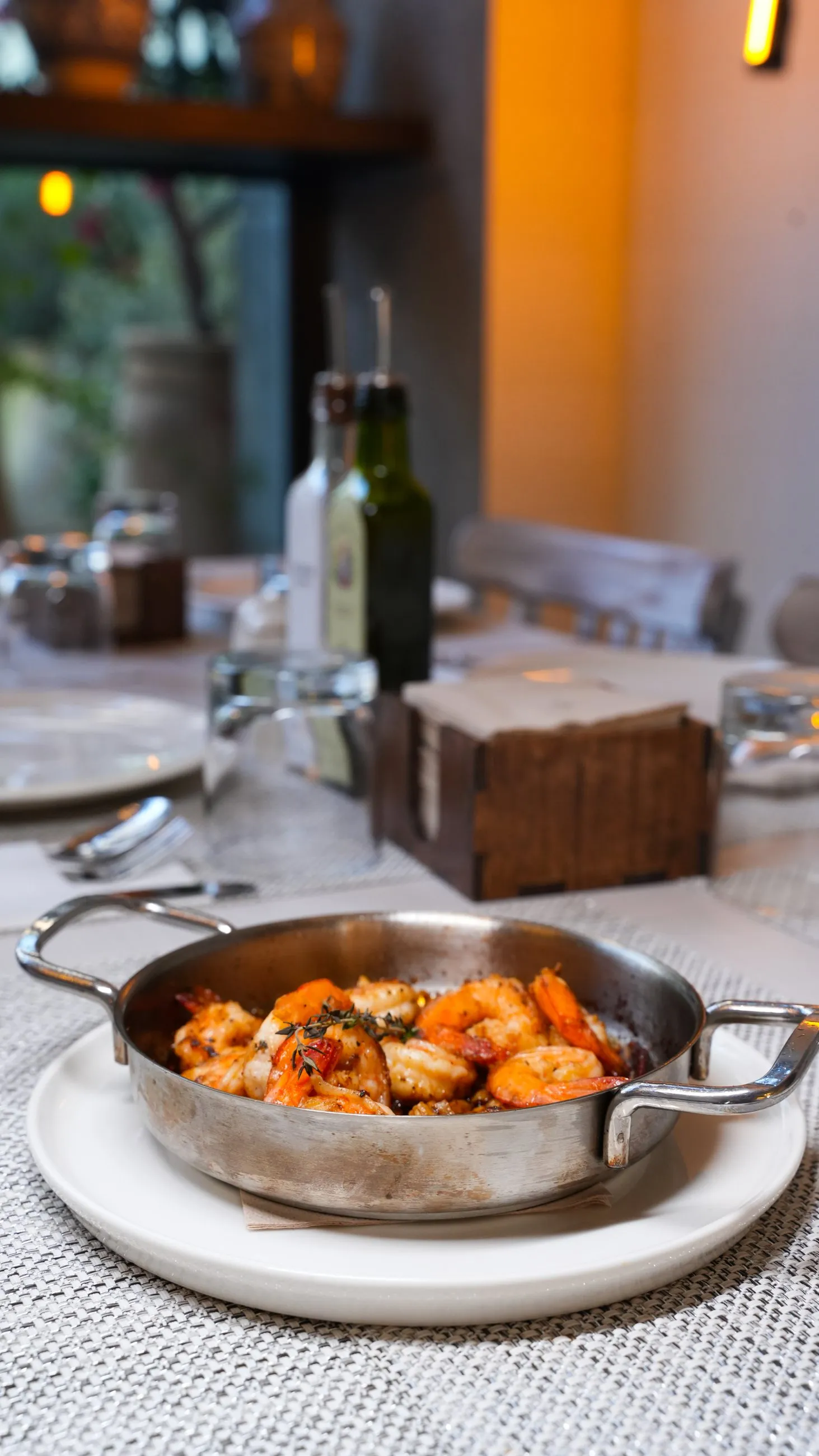 Prawns served warm in a small copper pan