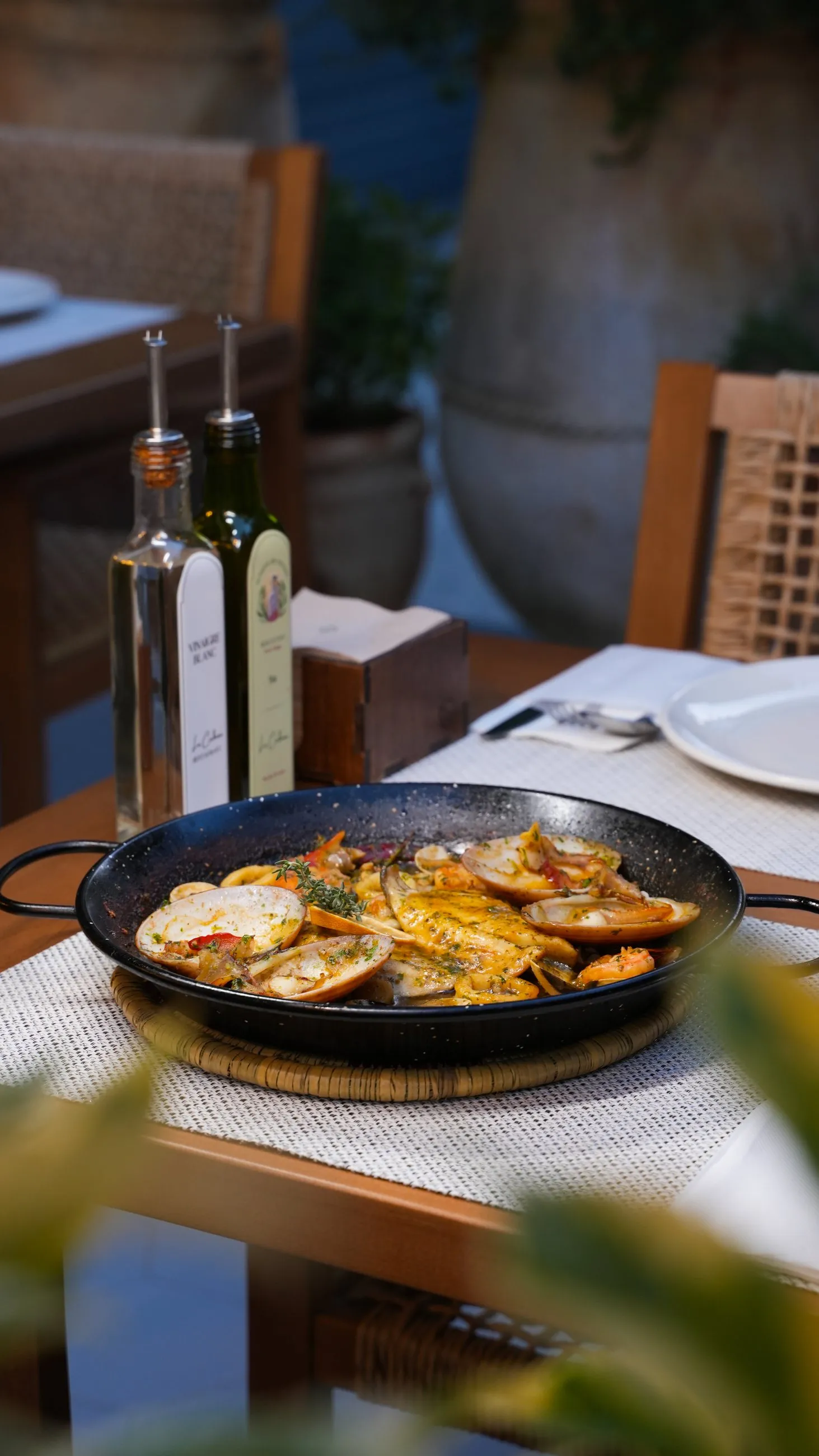 Seafood paella brought to the table in its pan