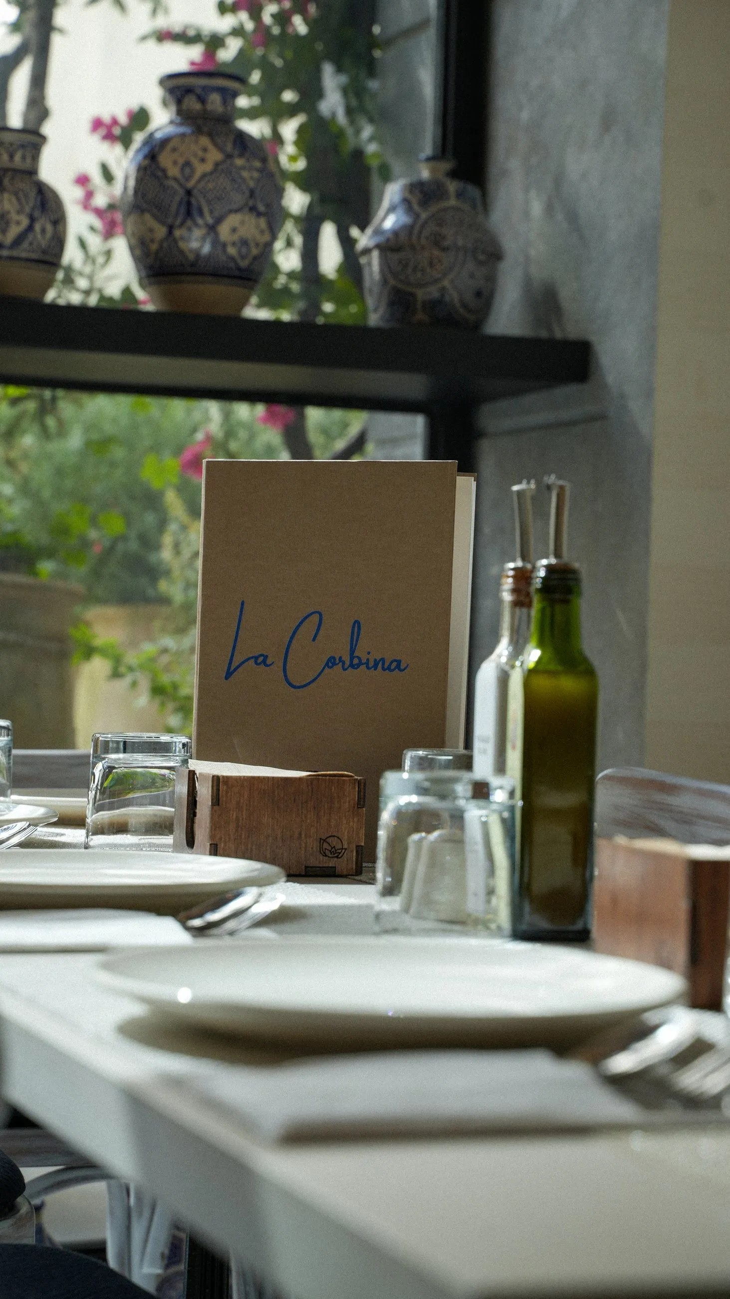 The La Corbina menu on a sunlit table