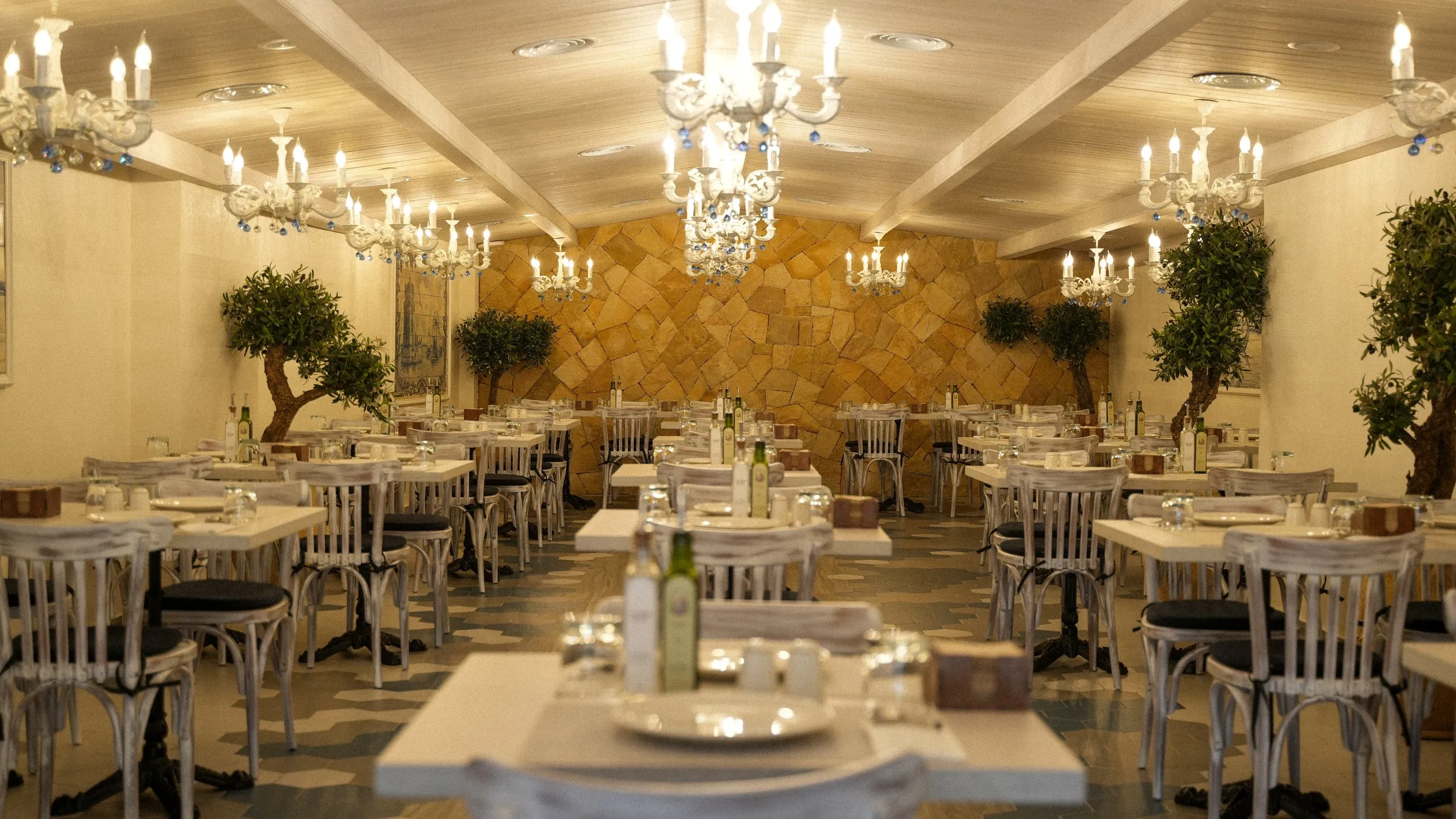 The warm dining room with crystal chandeliers